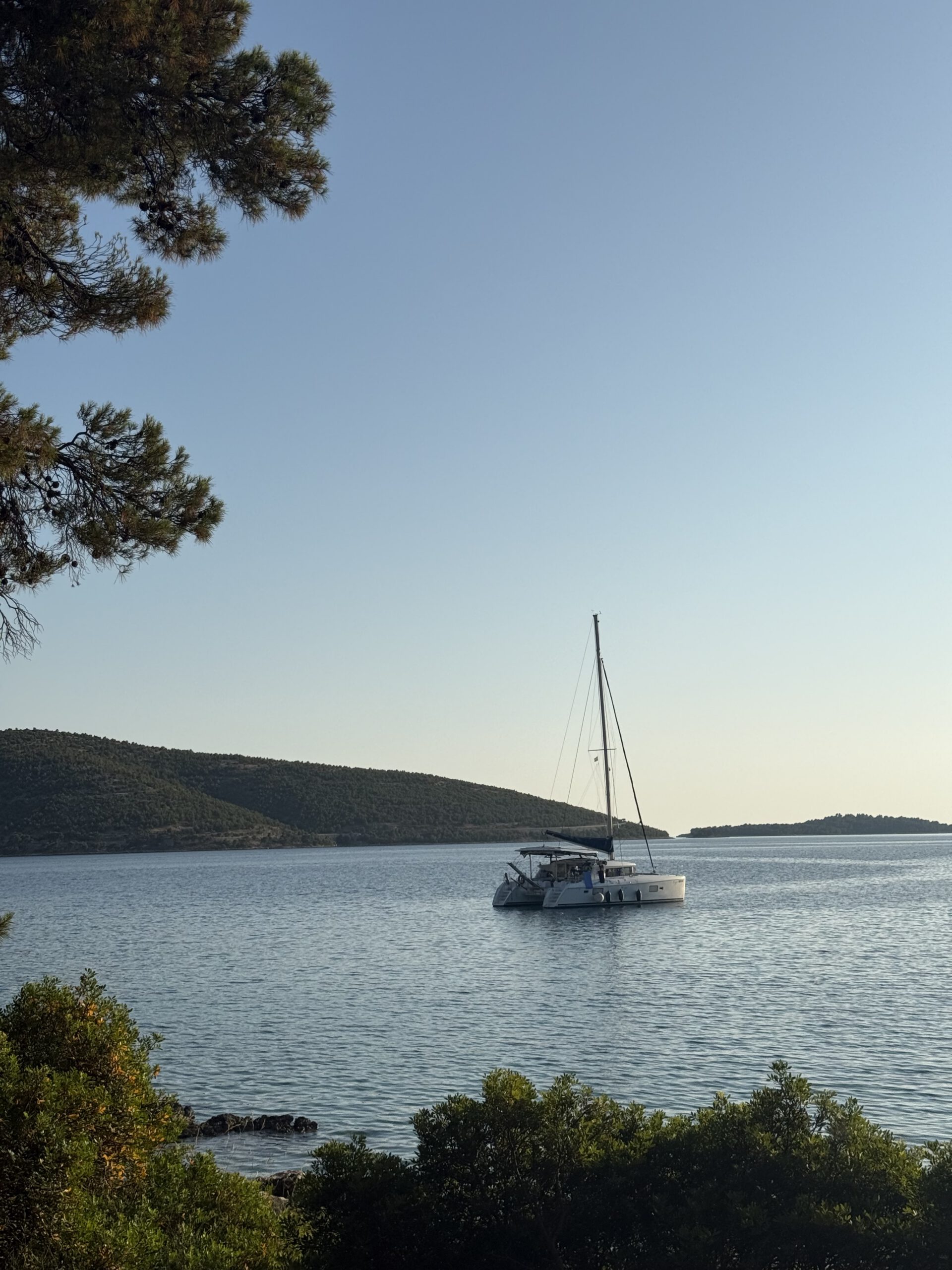 Guest taking a photo of the catamaran Eragon on the water